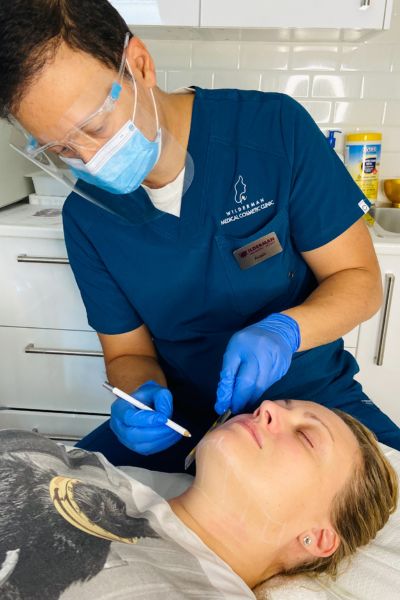 Image of a patient preparing to receive Ultherapy treatment on different areas of the face.
